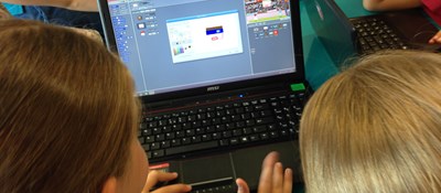 Children having a go at coding on a laptop during a library taster session in Glasgow, September 2014, enabled by the installation of WiFi.