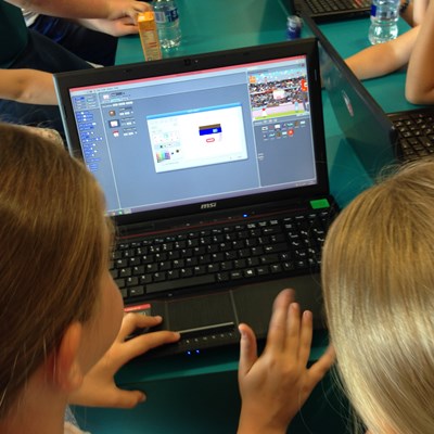 Children having a go at coding on a laptop during a library taster session in Glasgow, September 2014, enabled by the installation of WiFi.